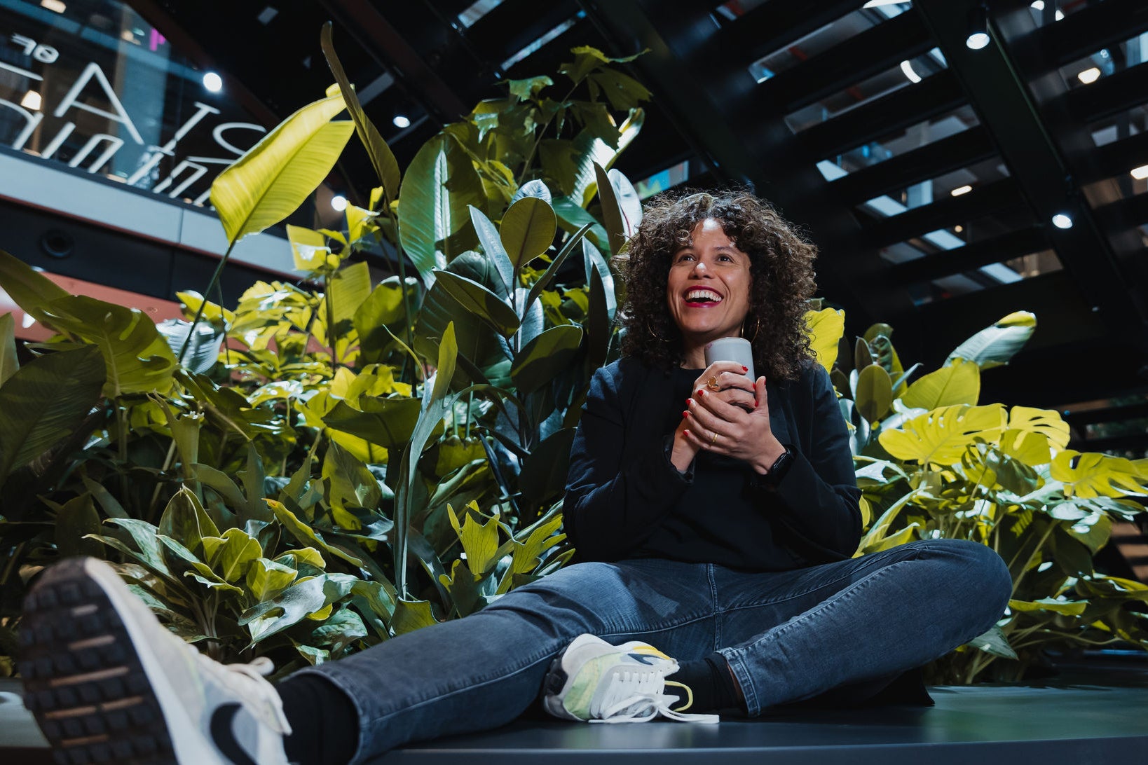 woman sitting in front of plants
