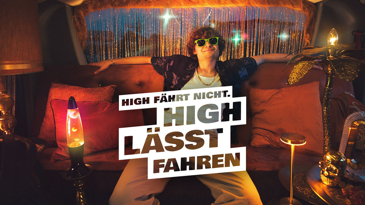 guy with sunglasses sitting relaxed in a cozy lounge