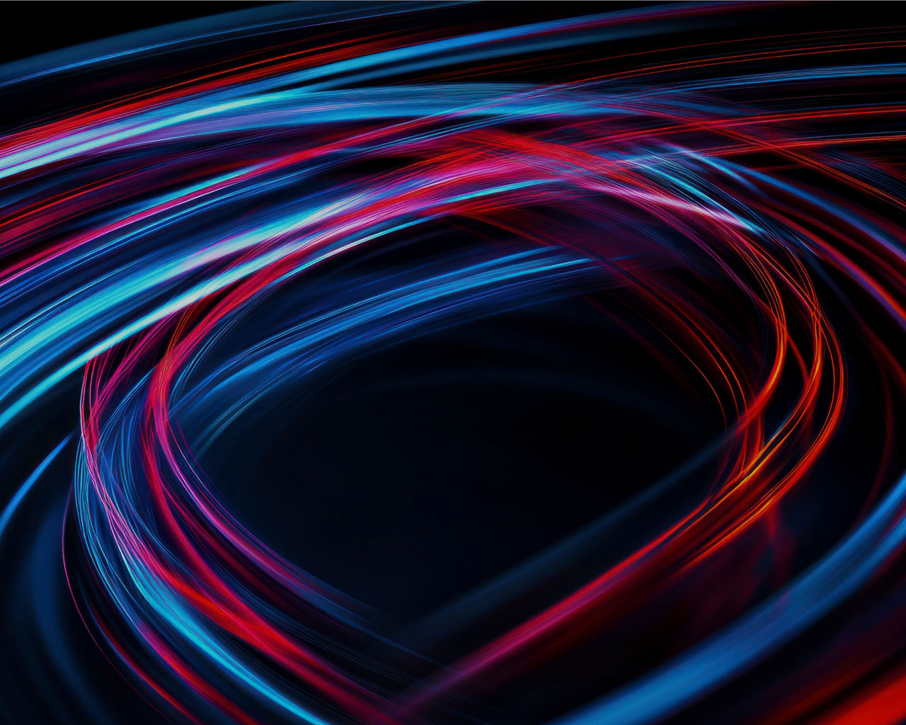 Abstract image of dynamic blue and red light trails on a black background.