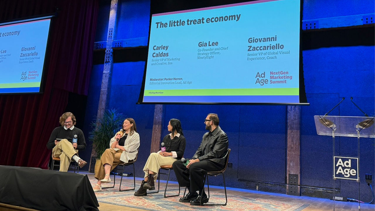Sunny city street with parked cars, trees, and modern buildings. A banner for the SXSW festival hangs from a lamppost.