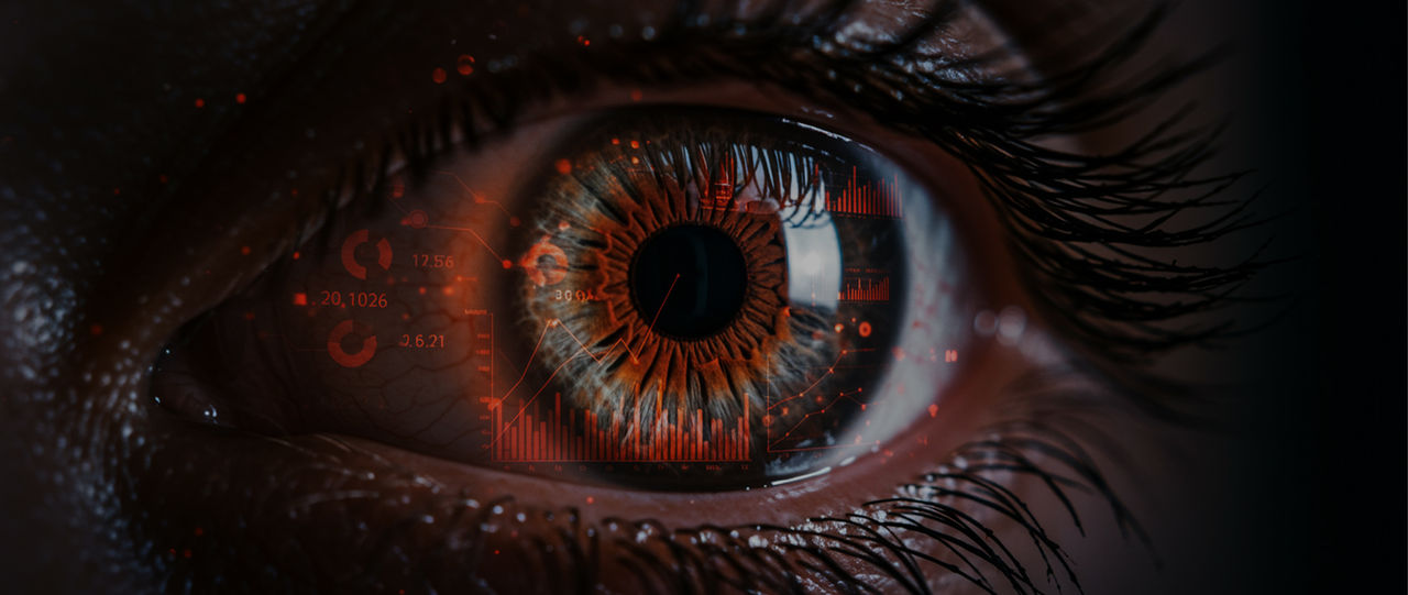 close-up shot of an eye with data and graphs mirrored on the iris